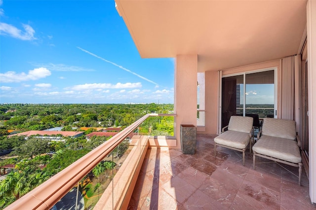 balcony featuring a forest view