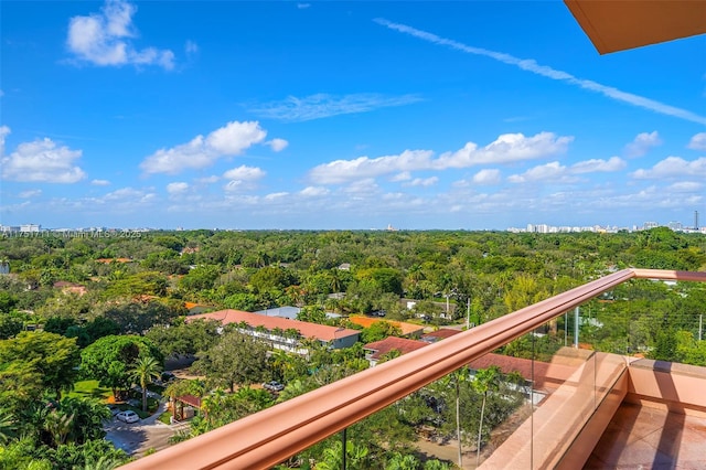 balcony featuring a view of trees