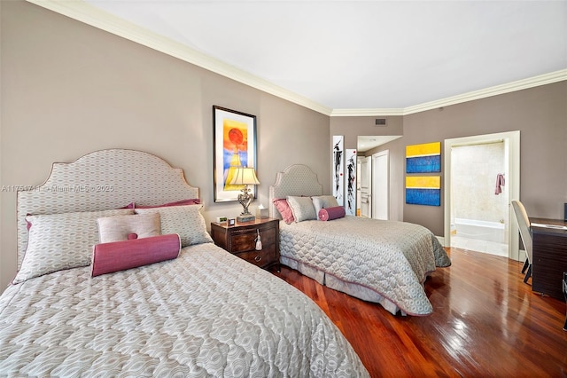 bedroom with crown molding, visible vents, and wood finished floors