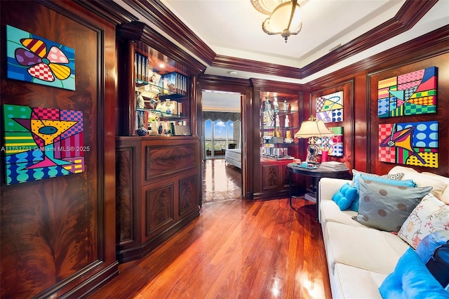 home office with crown molding and wood finished floors