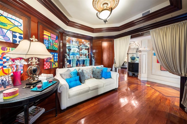 interior space featuring ornamental molding, wood finished floors, and visible vents