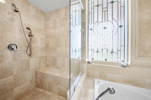 bathroom featuring a tile shower and a bath