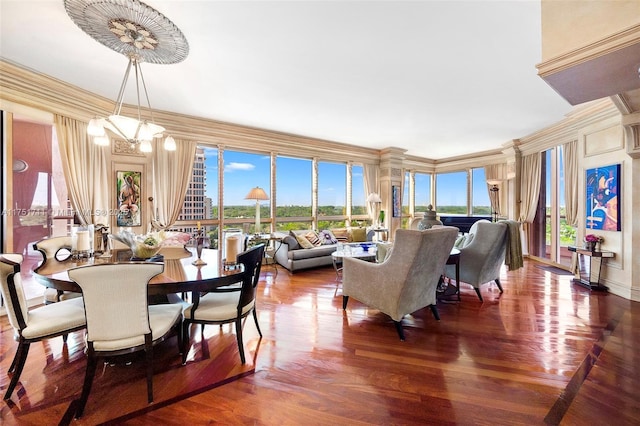 dining area featuring a healthy amount of sunlight, crown molding, and wood finished floors