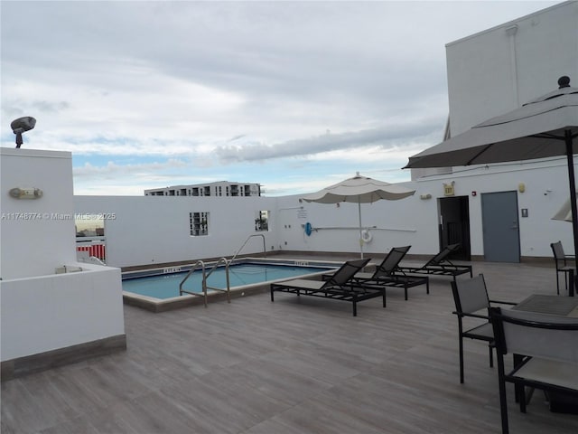 community pool featuring a wooden deck