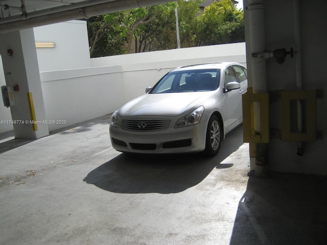 view of vehicle parking featuring fence