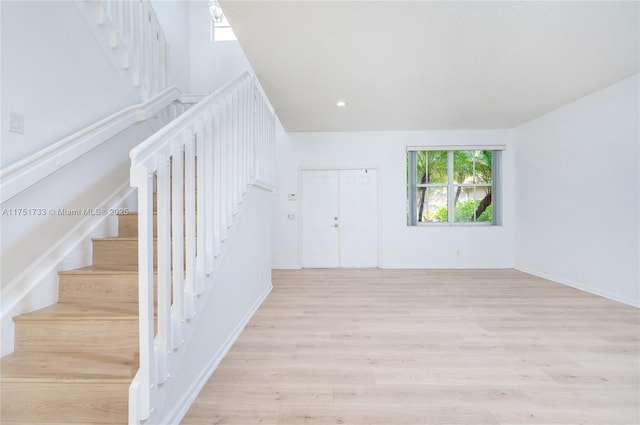 interior space with recessed lighting, stairway, light wood-style floors, and baseboards
