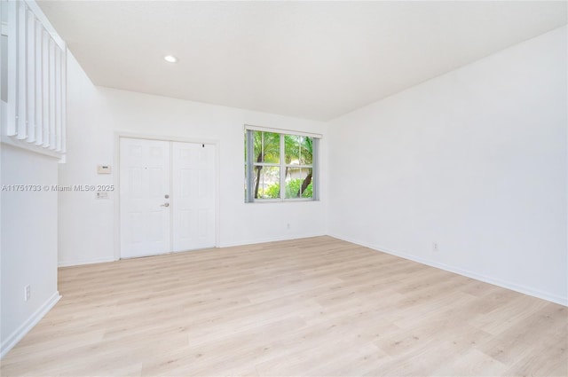 unfurnished room featuring light wood-type flooring, baseboards, and recessed lighting