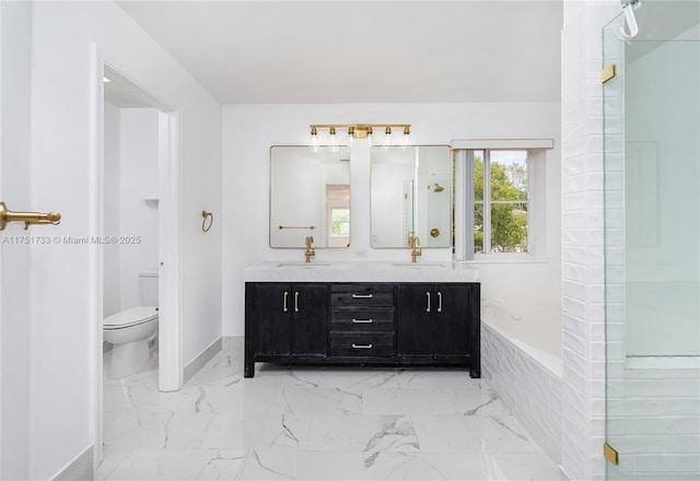 full bathroom featuring toilet, marble finish floor, a sink, double vanity, and baseboards