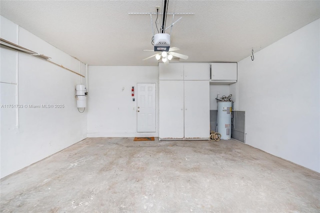 garage featuring water heater, a garage door opener, and a ceiling fan