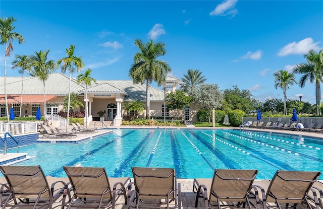 community pool featuring a patio area and fence