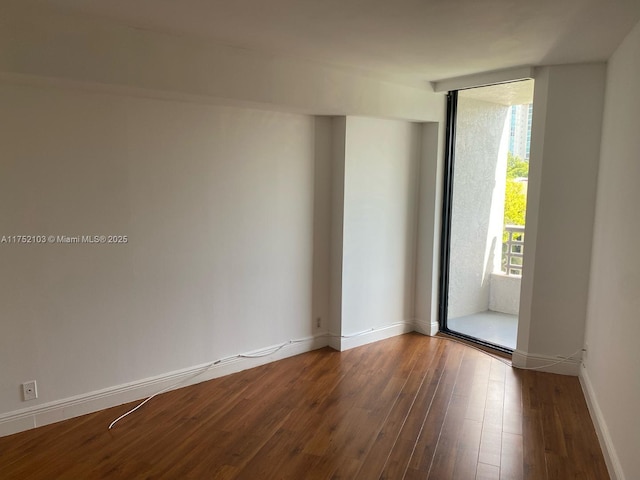3300 NE 191st St Unit 416, Aventura, FL 33180 - spare room featuring expansive windows, baseboards, and wood finished floors