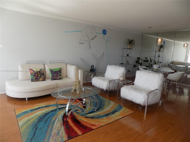 living room with wood finished floors and crown molding