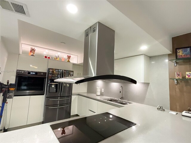 1301 NE Miami Gardens Dr Unit 501W, Miami, FL 33179 - kitchen featuring a sink, visible vents, white cabinetry, black appliances, and island exhaust hood