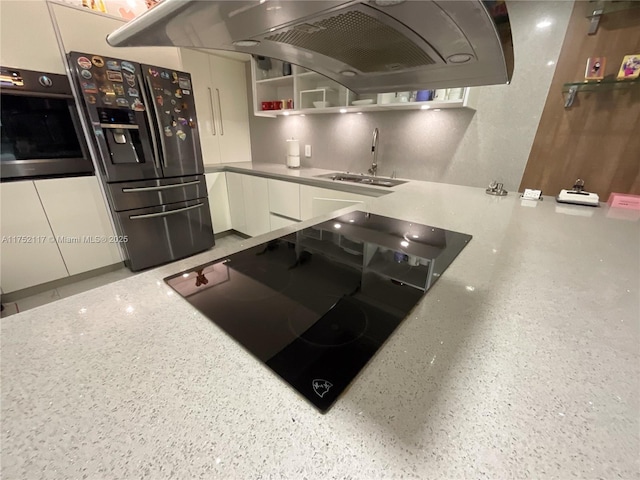 kitchen with open shelves, oven, range hood, stainless steel refrigerator with ice dispenser, and a sink