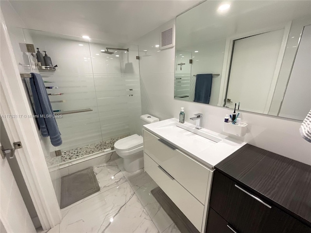 bathroom featuring marble finish floor, visible vents, toilet, a stall shower, and vanity