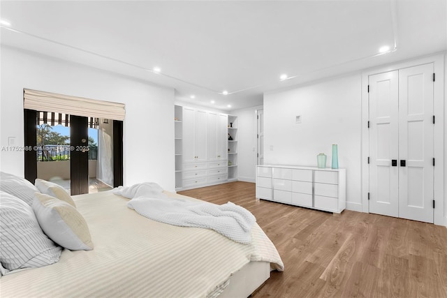 bedroom with access to exterior, a closet, recessed lighting, and light wood-style floors