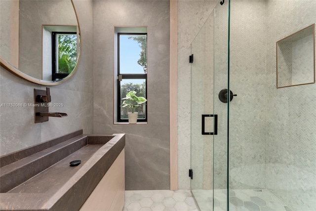 full bathroom featuring a shower stall and tile walls