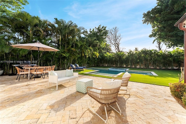 view of patio / terrace with outdoor dining area, an outdoor pool, and an outdoor hangout area