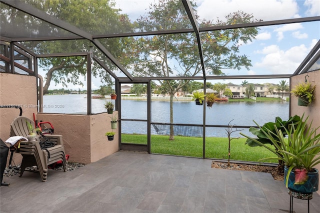 unfurnished sunroom with a water view and a healthy amount of sunlight