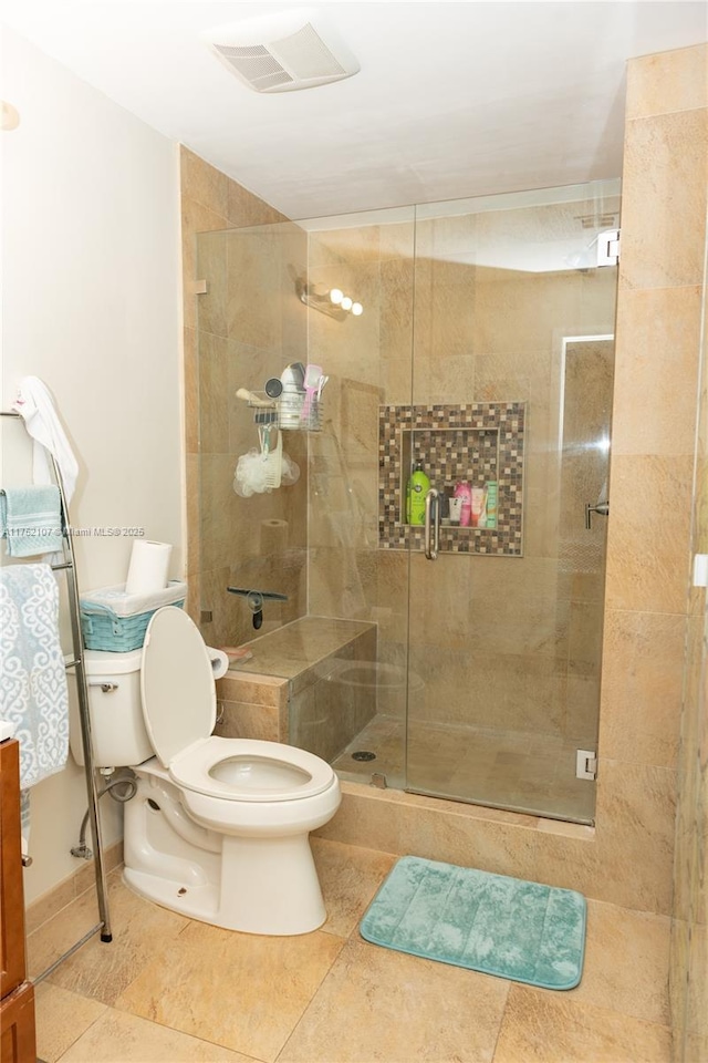 full bathroom with toilet, a shower stall, visible vents, and tile patterned flooring