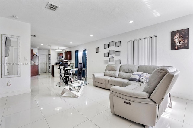 living room with baseboards, recessed lighting, visible vents, and a textured ceiling