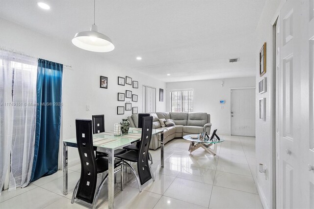 dining space with light tile patterned floors, visible vents, and recessed lighting