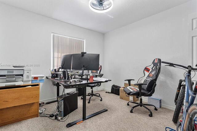 home office featuring baseboards and carpet