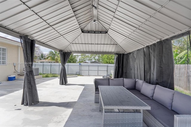 view of patio with a gazebo, an outdoor hangout area, and a fenced backyard