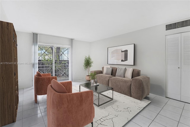 living room featuring light tile patterned floors and visible vents