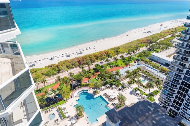 bird's eye view with a water view and a beach view