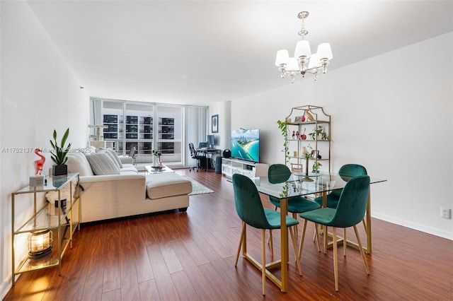 dining area featuring dark wood-style floors, floor to ceiling windows, baseboards, and a notable chandelier