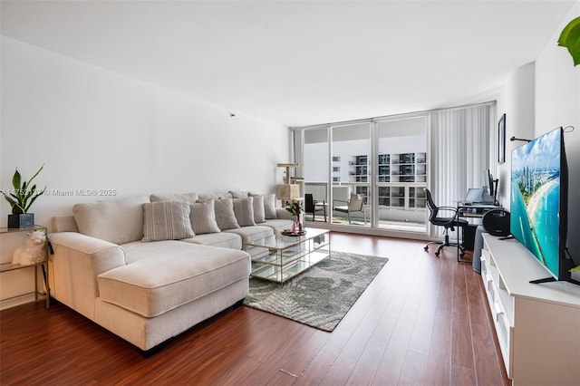 living room featuring dark wood finished floors and a wall of windows