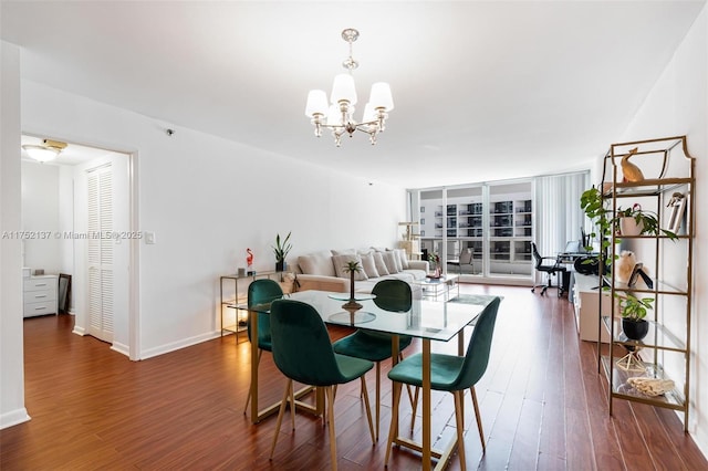 dining space featuring baseboards, dark wood-type flooring, a wall of windows, and an inviting chandelier