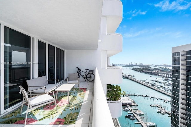 balcony with a water view and a city view