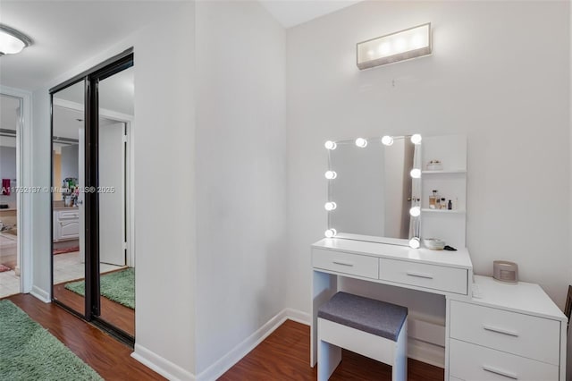 office space with dark wood finished floors and baseboards