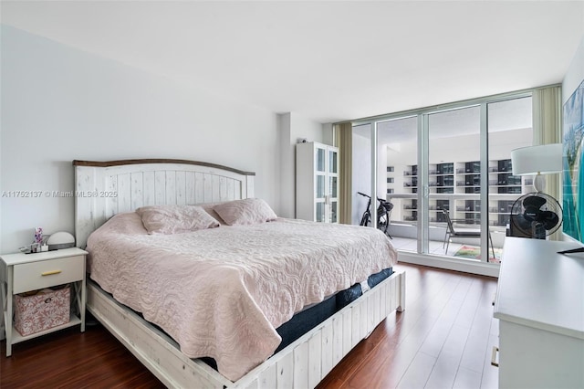 bedroom featuring dark wood-style floors, access to outside, and expansive windows