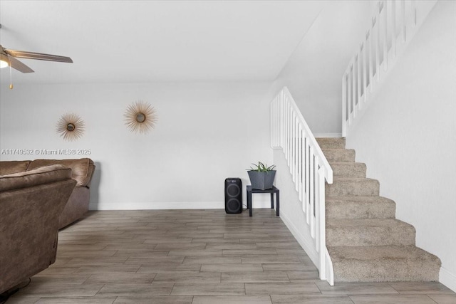 interior space with wood tiled floor, baseboards, and a ceiling fan