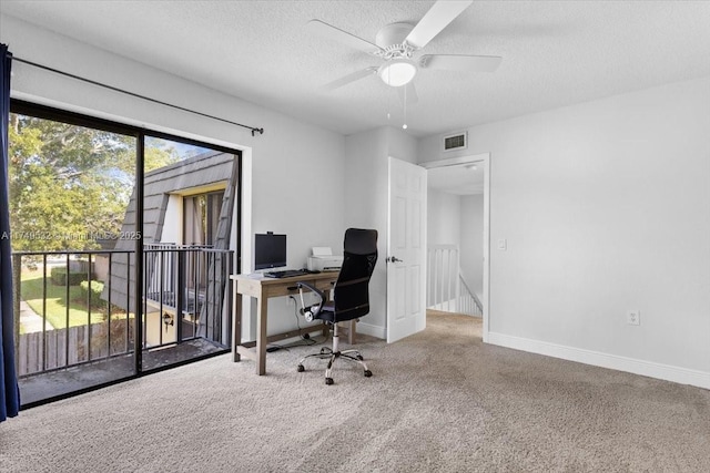 carpeted home office featuring visible vents, ceiling fan, a textured ceiling, and baseboards