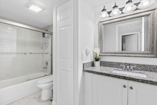 full bath featuring toilet, marble finish floor, bath / shower combo with glass door, and vanity