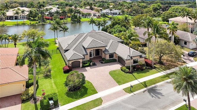 drone / aerial view featuring a water view and a residential view