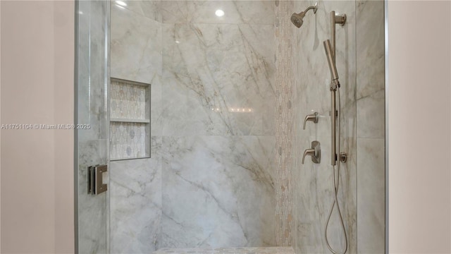 bathroom with a marble finish shower