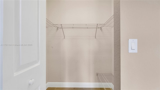 spacious closet with wood finished floors