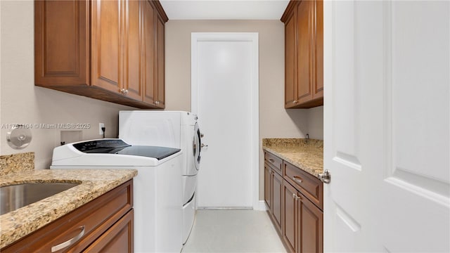 washroom featuring separate washer and dryer and cabinet space