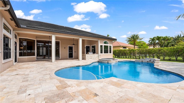 view of swimming pool with a pool with connected hot tub, ceiling fan, fence, and a patio