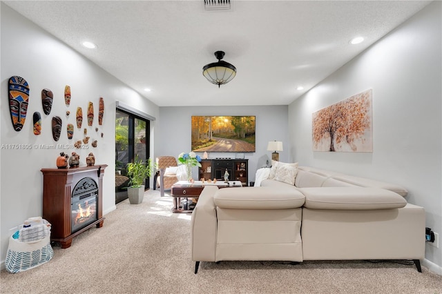 living area featuring recessed lighting, light colored carpet, and visible vents