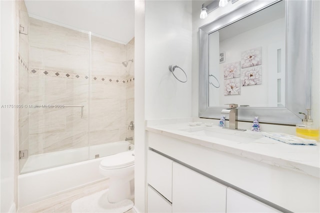 bathroom with toilet, bath / shower combo with glass door, and vanity