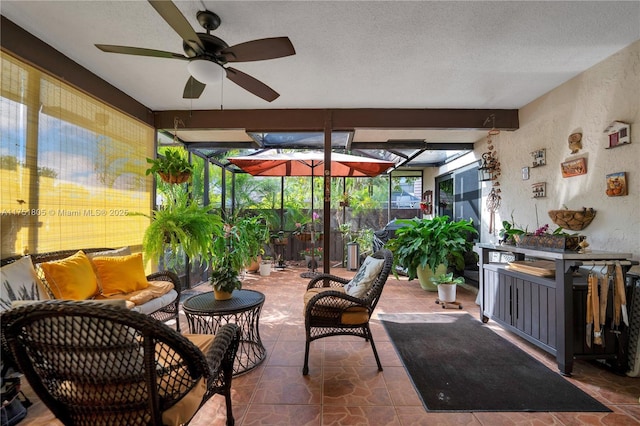 sunroom featuring a ceiling fan