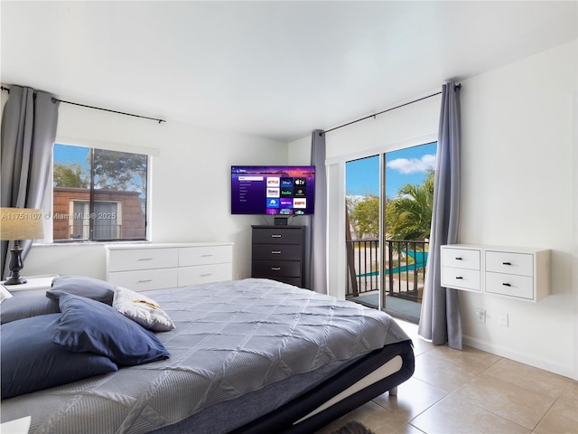 bedroom with access to exterior and light tile patterned flooring