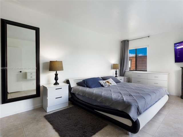 bedroom with light tile patterned floors