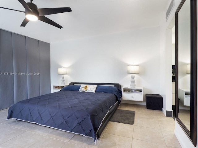 bedroom with a ceiling fan, visible vents, and light tile patterned floors